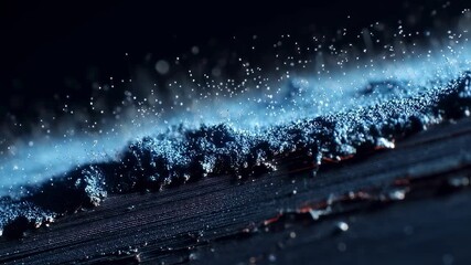 Poster - Innovative nanotechnology is creating a glowing blue material, forming a wave like pattern on a dark textured surface, showcasing advancements in material science and futuristic possibilities