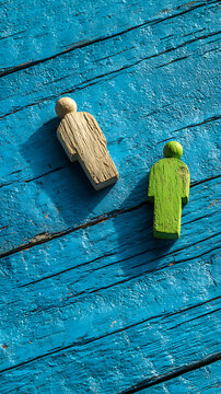 Wooden figures on weathered blue planks people green