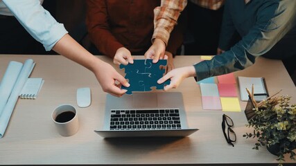 Poster - A vibrant scene of diverse professionals engaged in teamwork around a modern office desk, showcasing collaboration through colorful puzzle pieces and a laptop, inspiring creativity. SACTR