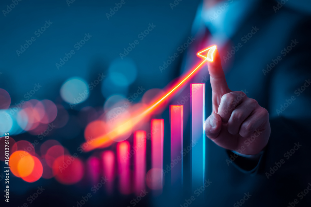 Business professional pointing at a glowing growth bar chart with ...