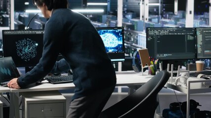 Poster - Data center technician entering office, managing AI systems for uptime and efficiency. IT professional arriving at work, sitting at desk, using artificial intelligence in server hub, camera A