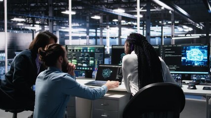 Fototapete - Teamworking data center technicians using machine learning algorithms to analyze large datasets. Server room colleagues gathered together at desk, collaborating, using AI neural networks, camera A