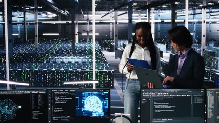 Poster - Data center engineers managing AI systems for uptime and efficiency, looking over paperwork files. African american woman and Asian man reading documents in multiethnic server hub, camera A