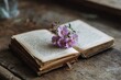 © VolumeThings - Cherished writing on open notebook with a flower on a wooden surface