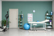 © Pixel-Shot - Interior of physiotherapist's office with couch, shelf units and exercising bike