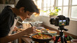 © Muhammad - Teenager cooking and filming a recipe for a food blog or social media channel in a bright kitchen