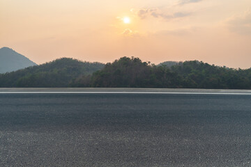 side view of asphalt road with landscape of sunset sky. road background