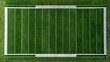 © KPMusa - Top-down view of football field with precision-cut grass and bright hash marks sun directly overhead casting short crisp shadows