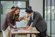 © aekachai - Group of business people are having a meeting at the office.