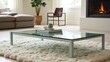 © ikhsan - Light teal-colored glass coffee table on a cream-colored rug in a modern living room.