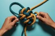 © TawhidulIslam - Hands Untangling Intertwined Ropes - Solving Complex Problems & Business Challenges