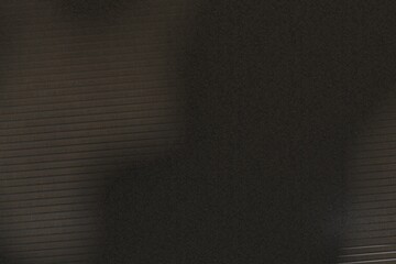 dark brown background with horizontal lines fading into a mottled, granular area.  The lines suggest a structured element contrasting with the organic texture of the mottled section.