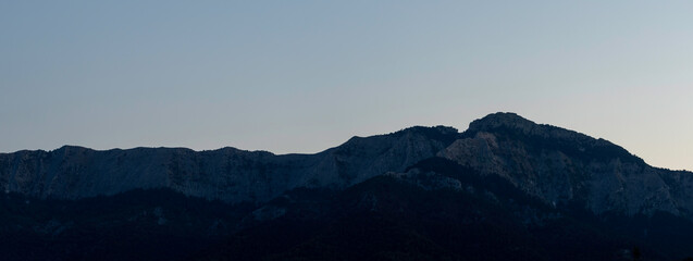 Wall Mural - panorama mountain range under clear blue summer sky.