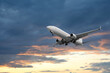 © New Africa - Airplane flying in beautiful sky with clouds at sunset