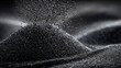 © SY - Fine black sand cascading onto a pile, against a dark, blurred background. Use this for concepts like time, texture, or the industrial applications.