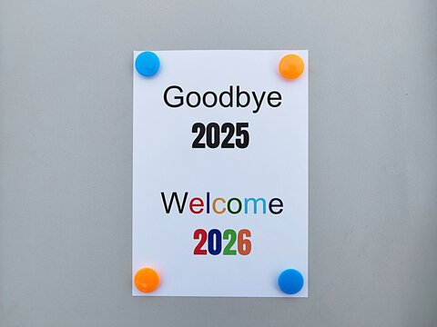 Paper written Goodbye 2025 Welcome 2026 with bright background, natural glow