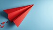 © Hungarian - Red paper airplane against a light blue background.