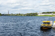 Yellow Motorboat Moored on a Scenic River with Fort in Background