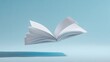 © Rumah - Open book levitating against light blue backdrop