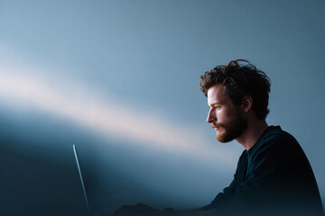 Poster - Focused man working on a laptop. Elegant minimalist style. Symbolizes concentration, tech, remote work, or creativity. Ideal for articles, ads, and websites.