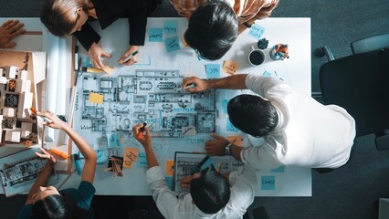 Poster - Top aerial view of project manager or civil engineer writing at blueprint and planning building design. Aerial view of architect working together at meeting table with document placed. Alimentation.