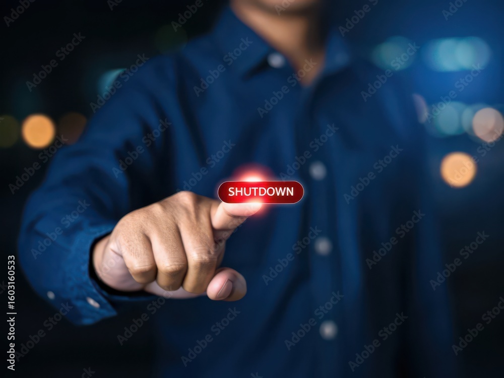 Person s finger pressing a glowing red shutdown button in a dark ...