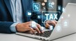 © Nuraya - Professional businessman managing taxes online with digital financial icons on modern laptop interface, seeking efficient solutions