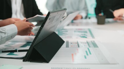 Poster - A group of business professionals collaborate on marketing strategies, analyzing reports and graphs on a table while utilizing a laptop in a modern office setting. SACTR
