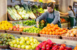 © JackF - Male salesman near fruit and vegetables stalls offering to buy limes