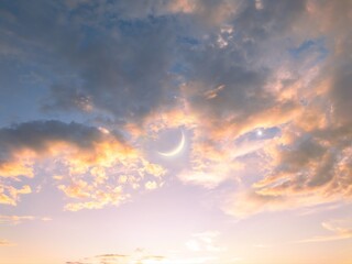 Wall Mural - new moon near star venus in the sky at sunset. moon and bright planet between clouds. astronomical l