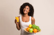 © Prostock-studio - Healthy eating. Woman holding tray of fruits and juice over light background