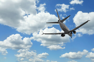 Wall Mural - airplane flying in beautiful blue sky with clouds