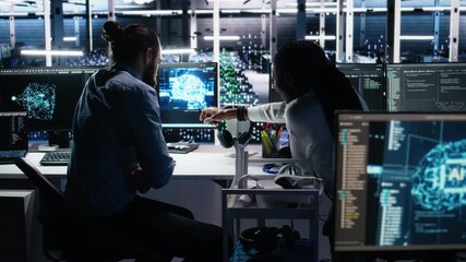 Poster - Data center admin teaching intern to monitor neural network using AI. IT expert and african american woman at work using artificial intelligence to oversee servers powering machine learning, camera A