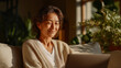 © Wasin Arsasoi - Contented moments of Remote Connection: A relaxed, middle-aged woman engages in an online communication on her laptop, smiling while natural light softly illuminates her home.