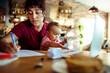 © Davor - Work from home mom with baby on video call in kitchen