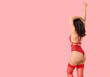 © Pixel-Shot - Sexy young woman in red underwear and stockings on pink background. Valentine's Day celebration