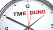 © Marsa - Close-up of a wall clock with the word 'TMEDUNG' displayed