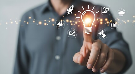 Poster - Man touching a light bulb with icons representing business and innovation on a gray background shirt