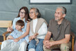 © Prapol Srinakara - portrait happy family,relationship,relaxing in coffee shop,sitting,embracing and looking to camera