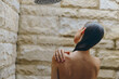 © SHOTPRIME STUDIO - Woman showering outdoors with water pouring from showerhead, wet hair, natural stone background, peaceful and refreshing morning routine atmosphere.
