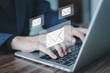 © Ben_24 - Businessman hands using Laptop typing keyboard on office table with email icon, email marketing concept, send or news letter, SMS marketing. Online working internet network.