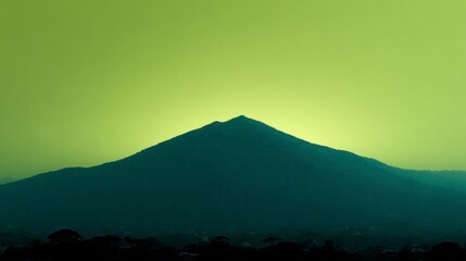 Wall Mural - Dark mountain silhouette against a vibrant yellow sky nature landscape