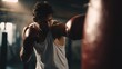 © Quail 8s Studio - fit man wearing boxing gloves hits  punching bag in  dimly lit gym Fitness