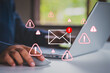 © LAONG - Email security threat and spam warning concept. Person click email with red warning icons and envelope representing email threats, phishing, spam alerts, cybersecurity risk in digital communication