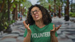 © Krakenimages.com - Middle age hispanic volunteer woman clenches fists near face and grimaces in green park; disgust frustration.