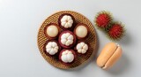 A fresh assortment of exotic Southeast Asian fruits featuring mangosteen, rambutan, and salak on a white background