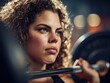 © Vincent - Golden-curled woman loading weight plate on shoulder red nail accents sculptural shadows low-angle gym lighting