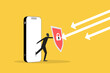 © Aan - Businessman protect from a smart phone with a shield