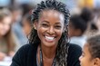 © Gatherina - Happy black teacher smiling at school with students