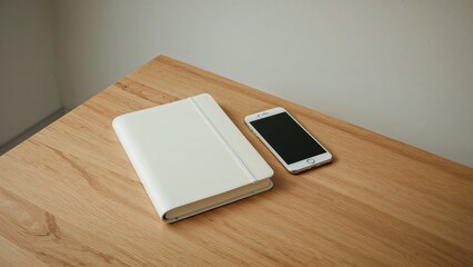 Poster - Blank notepad paired with a mobile device on a wooden tabletop.
